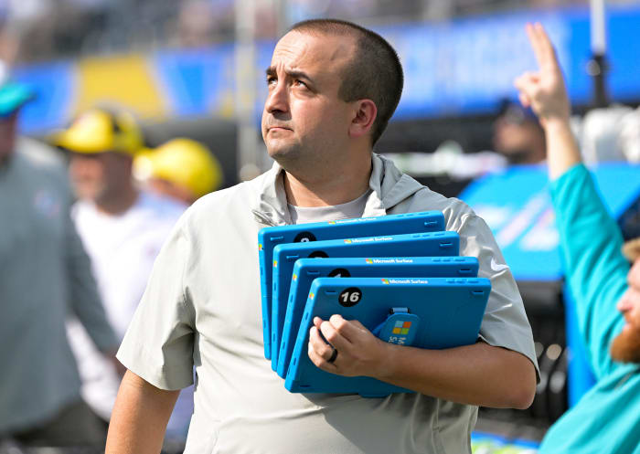 Dolphins football systems specialist Patrick Oliver holds Microsoft Surface tablets on the sideline.